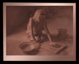 The Potter Mixing Clay